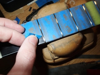 Pulling masking tape from a neck after a fret job